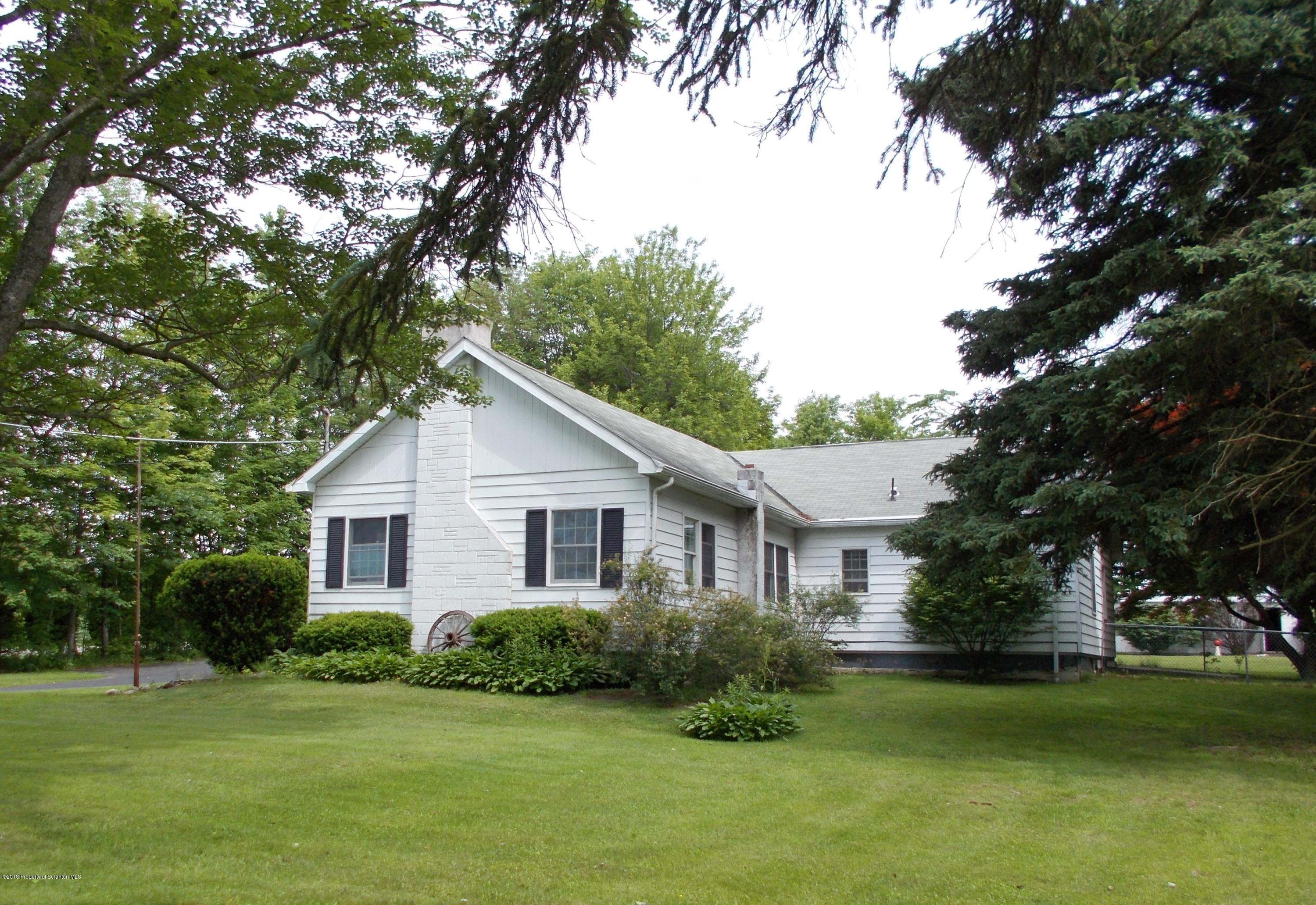 577 Pa-rt690 Road Moscow, PA 18444 - Photo 13 of 16 a front view of a house with a garden