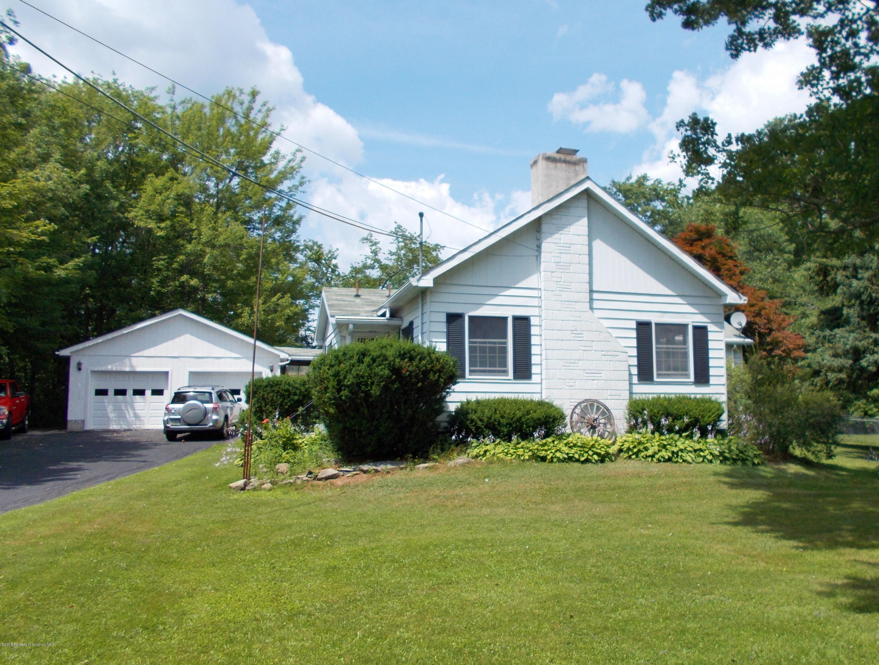577 Pa-rt690 Road Moscow, PA 18444 - Photo 15 of 16 a front view of a house with garden