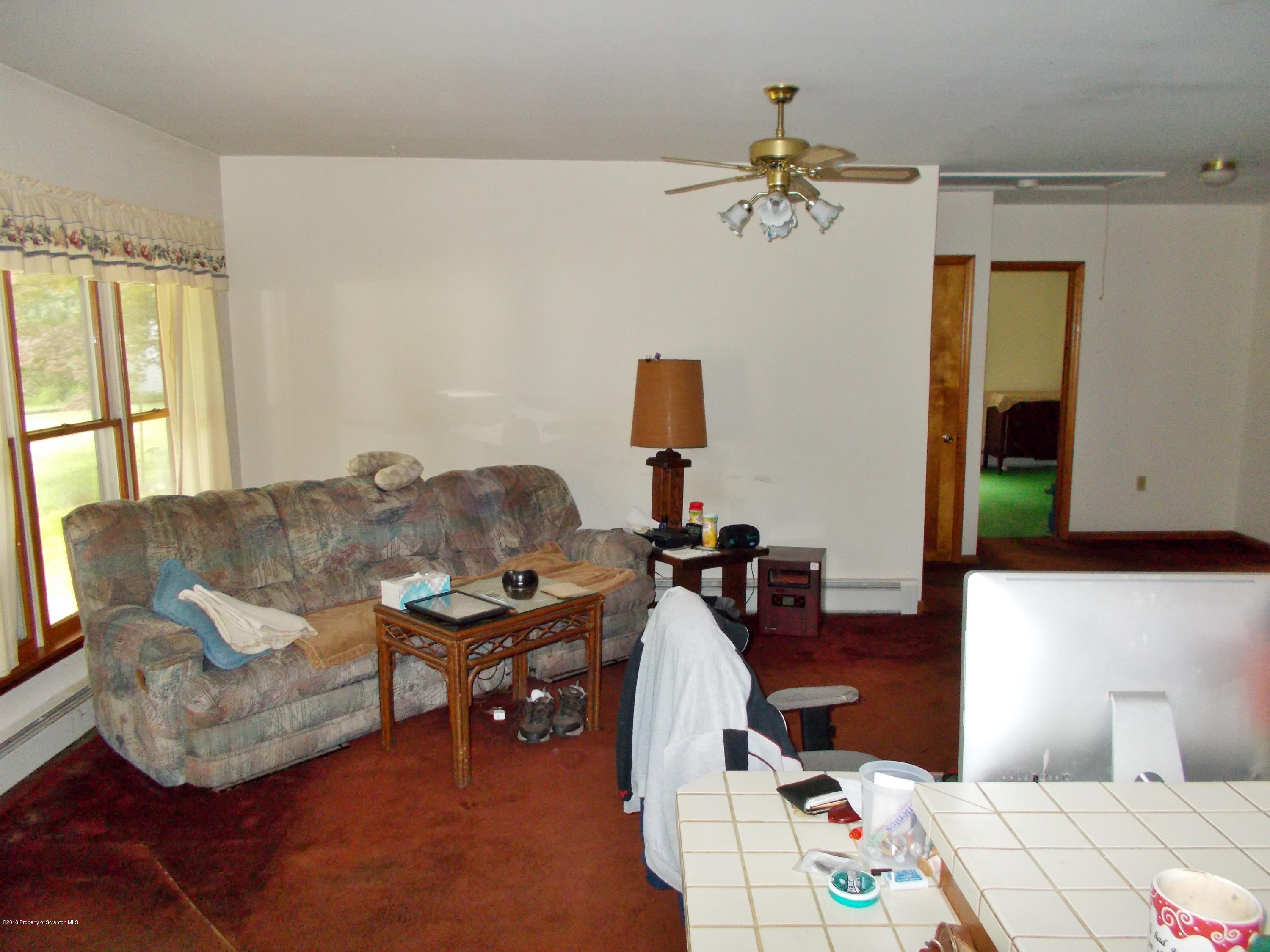 577 Pa-rt690 Road Moscow, PA 18444 - Photo 2 of 16 a living room with furniture and a chandelier