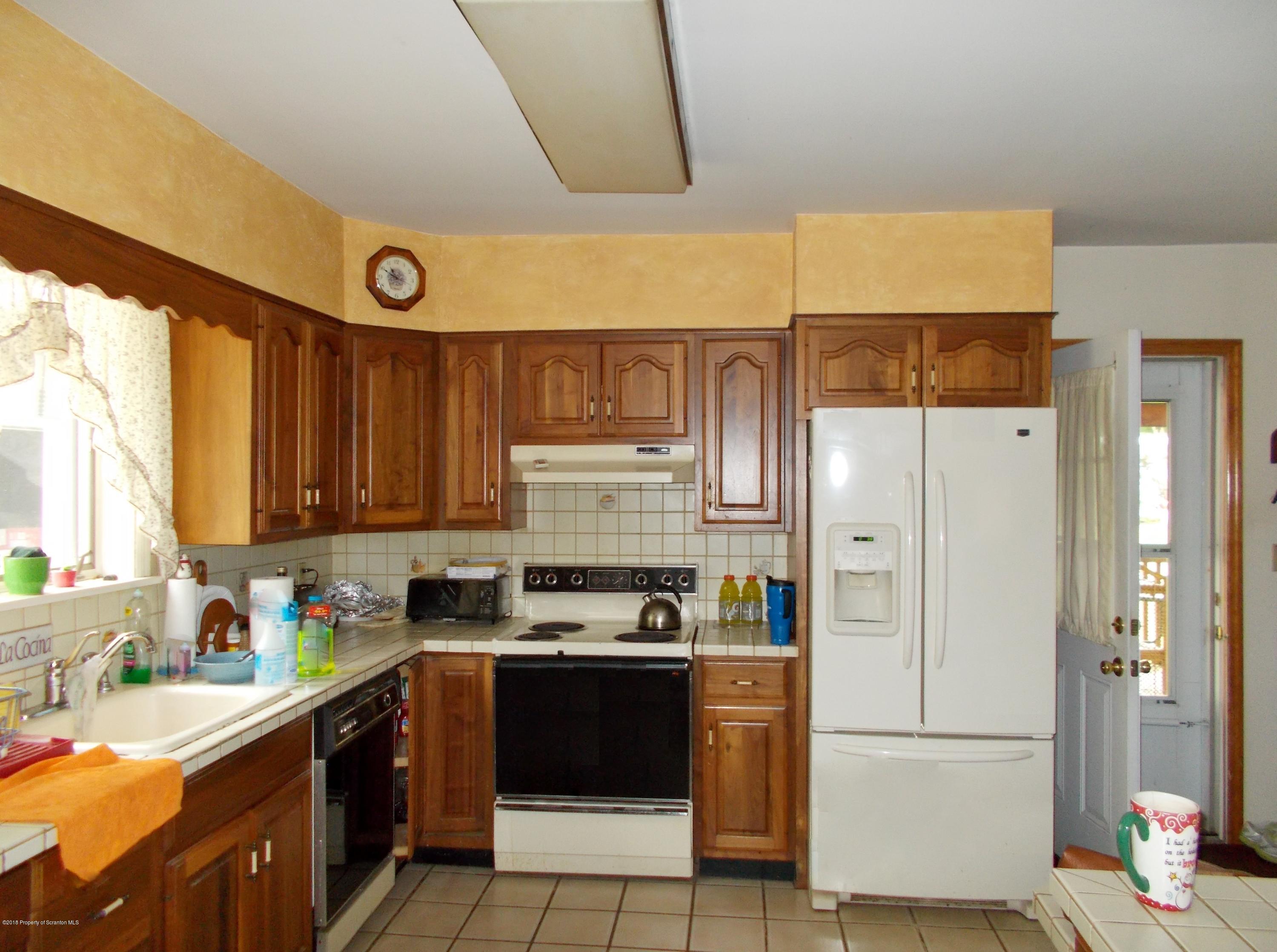577 Pa-rt690 Road Moscow, PA 18444 - Photo 4 of 16 a kitchen with stainless steel appliances granite countertop a refrigerator sink and cabinets