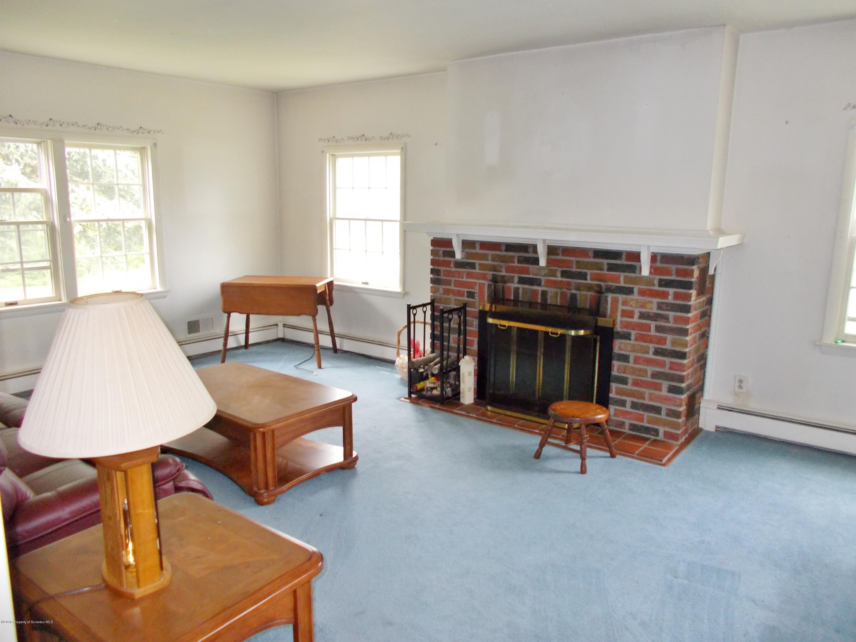 577 Pa-rt690 Road Moscow, PA 18444 - Photo 6 of 16 a living room with furniture and a fireplace