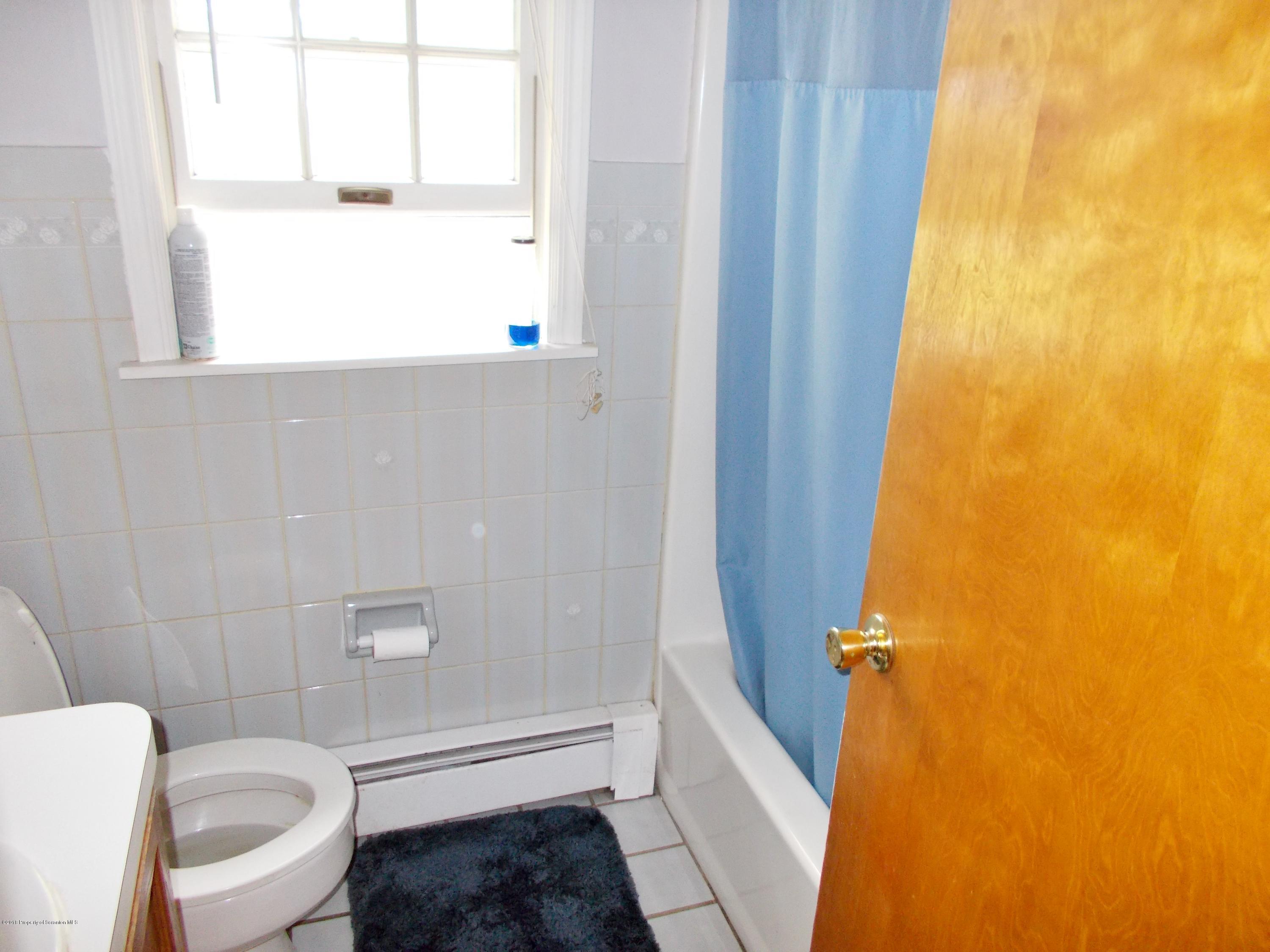 577 Pa-rt690 Road Moscow, PA 18444 - Photo 8 of 16 a bathroom with a toilet a sink and a window