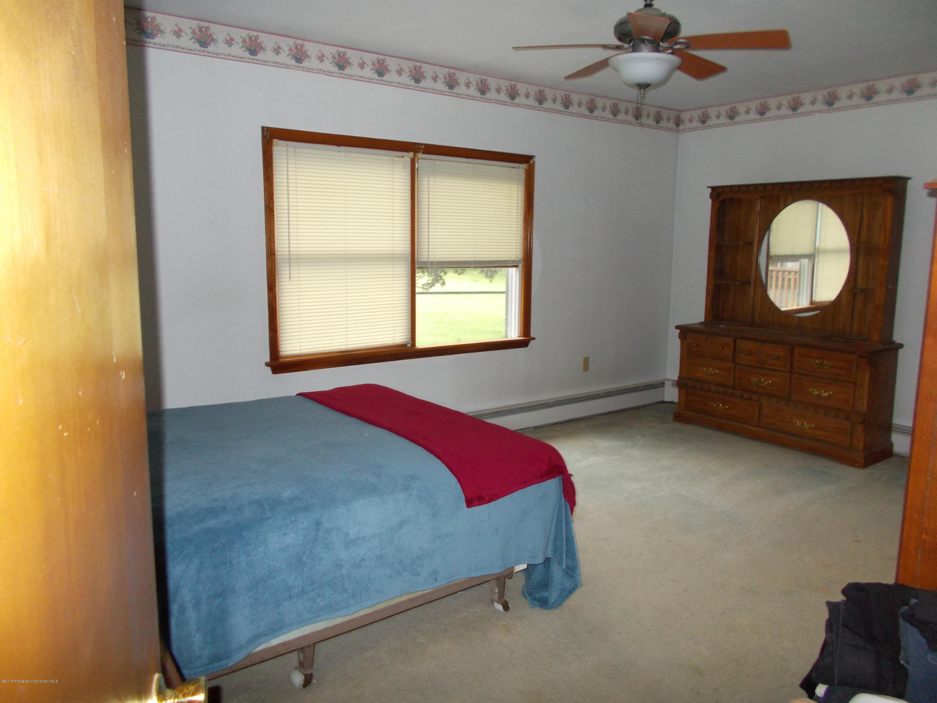 577 Pa-rt690 Road Moscow, PA 18444 - Photo 9 of 16 a bedroom with a bed and window