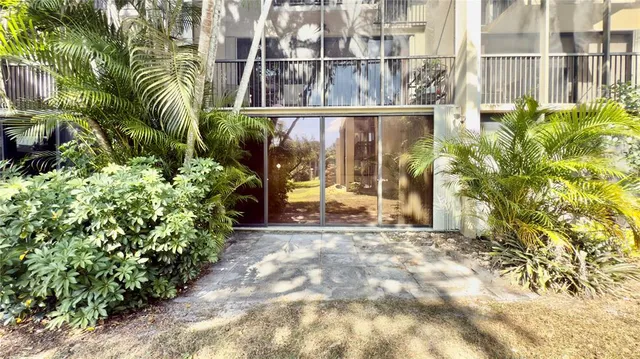 a view of a glass door with a yard