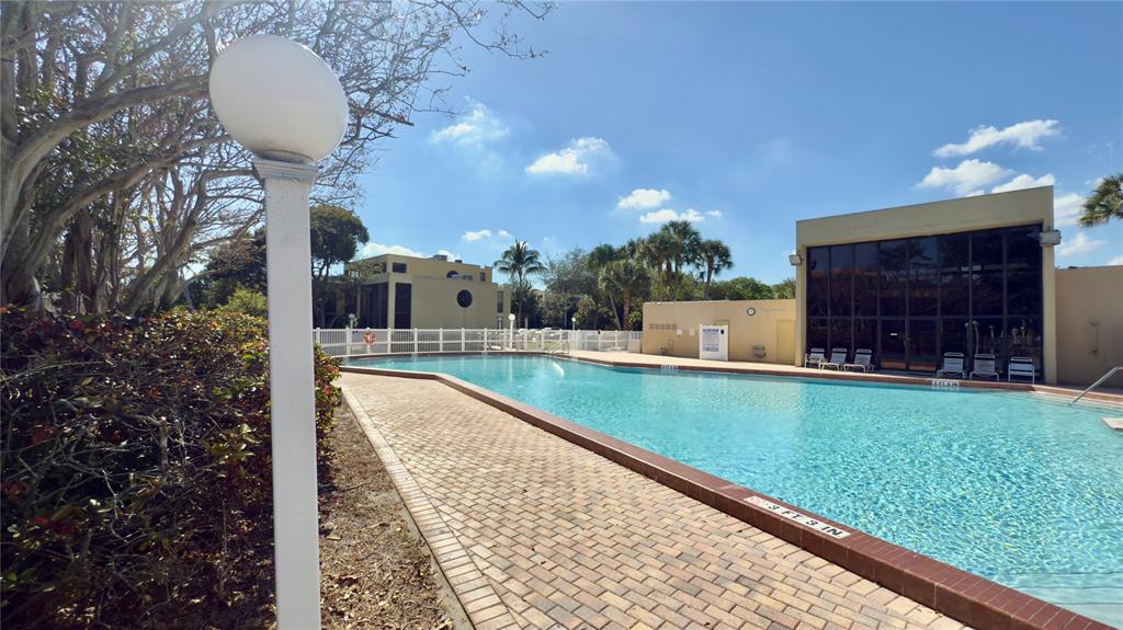 2941 Southwest 87th Avenue, Unit 403 Davie, FL 33328 - Photo 20 of 24 a view of a swimming pool with a patio and a yard