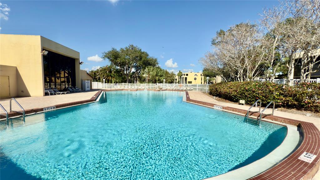 2941 Southwest 87th Avenue, Unit 403 Davie, FL 33328 - Photo 21 of 24 a view of a swimming pool with a garden