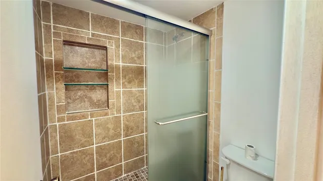 a bathroom with a glass shower door
