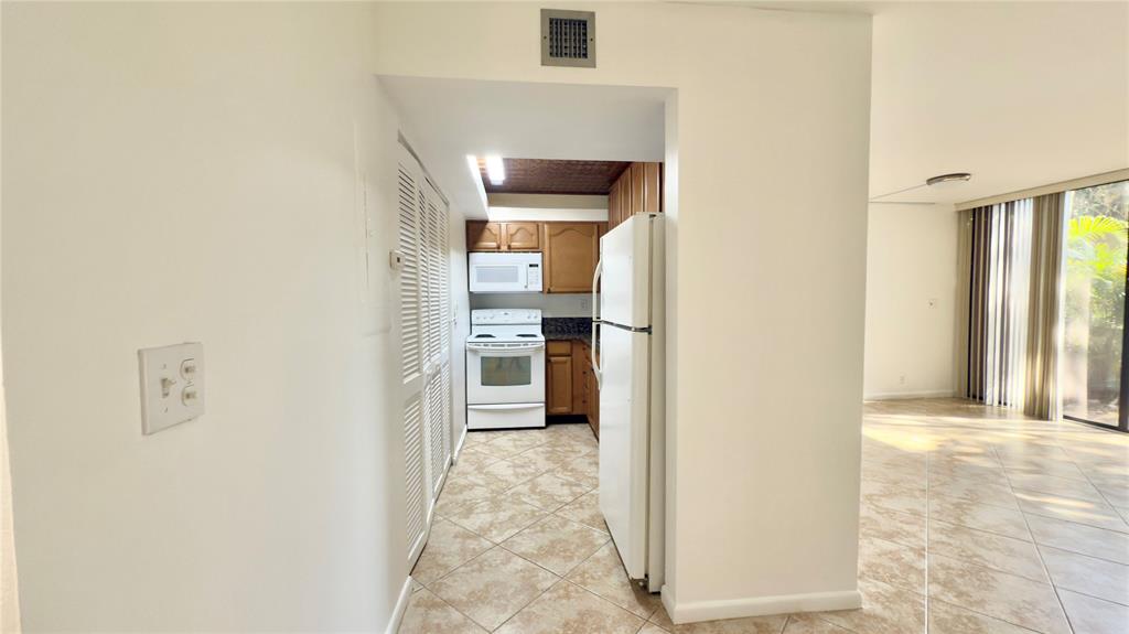 2941 Southwest 87th Avenue, Unit 403 Davie, FL 33328 - Photo 8 of 24 a view of a hallway with wooden floor and entryway