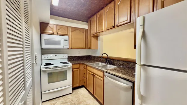 a kitchen with a stove a sink and a refrigerator