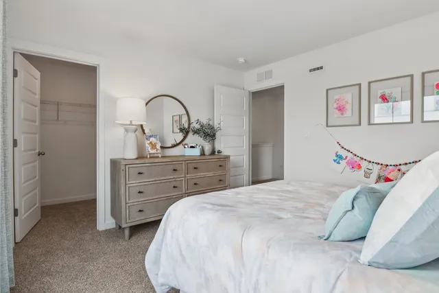 a bedroom with a bed and a dresser