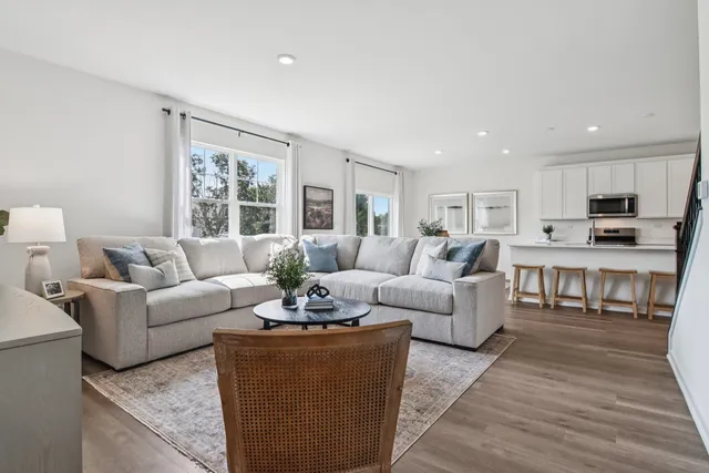 a living room with furniture and a large window