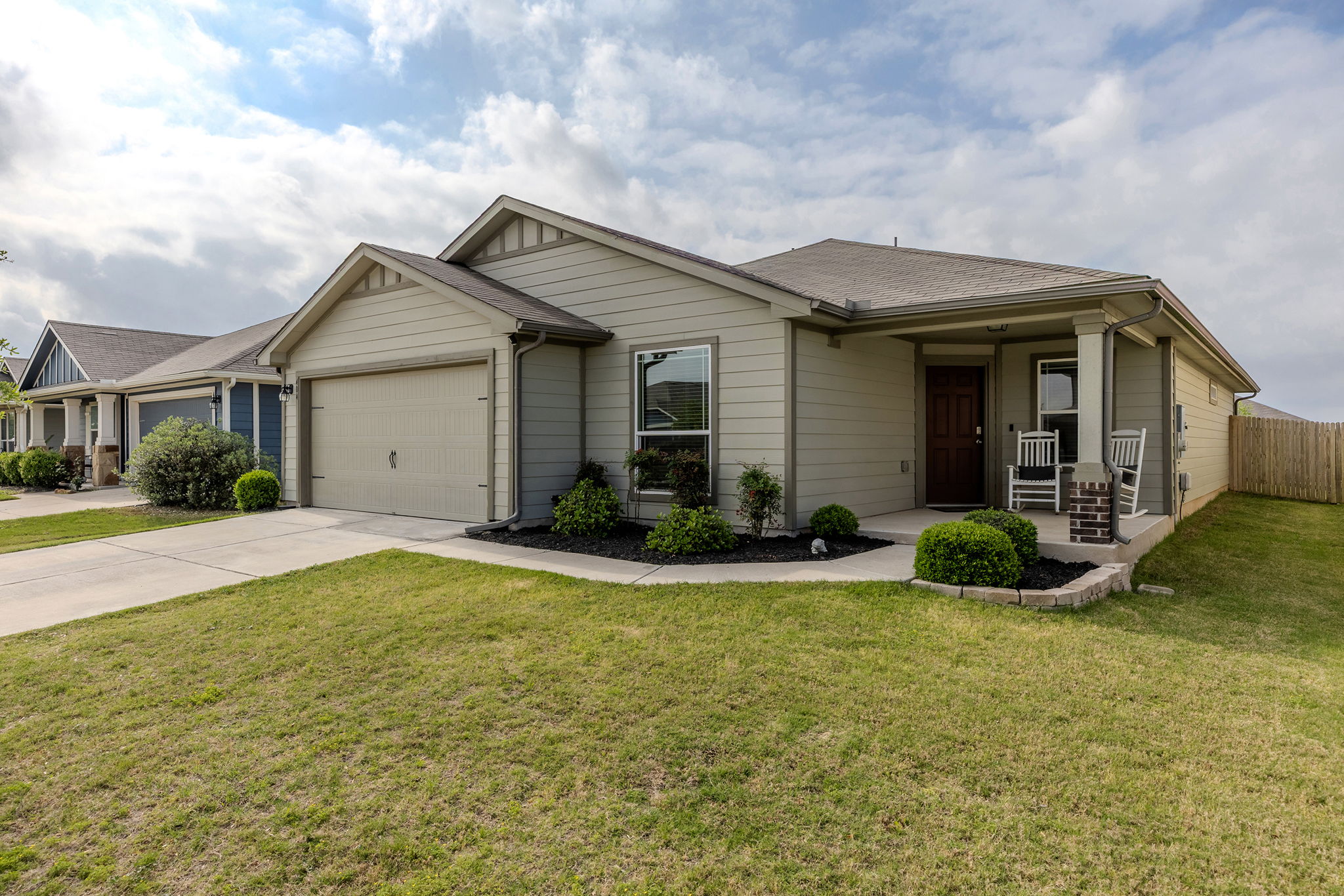 404 Cassandra Drive Hutto, TX 78634 - Photo 2 of 40 View of front of property with concrete driveway, a porch, an attached garage, and a shingled roof