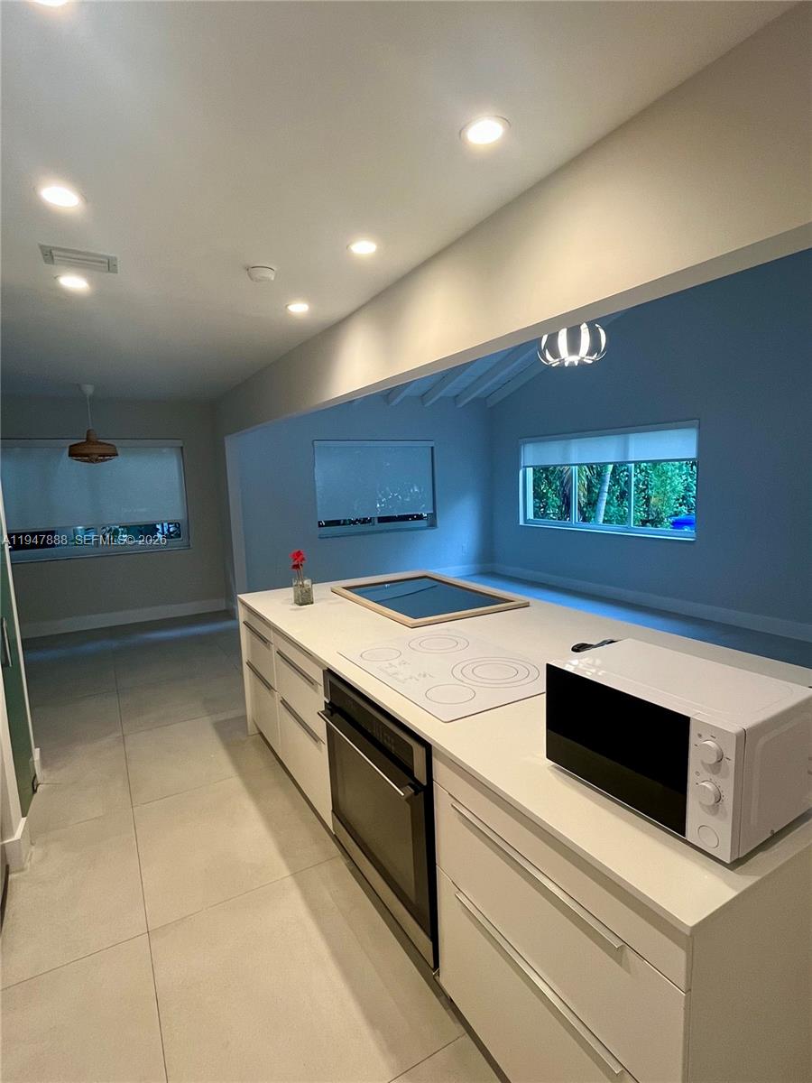 337 Southwest 23rd Road Miami, FL 33129 - Photo 14 of 30 a kitchen with stainless steel appliances granite countertop a sink and a stove