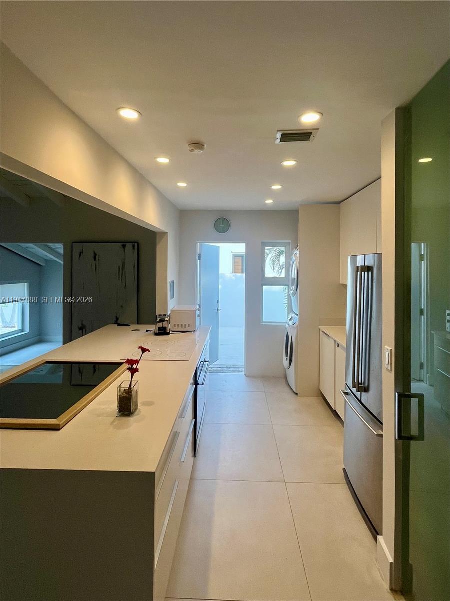 337 Southwest 23rd Road Miami, FL 33129 - Photo 15 of 30 a large kitchen with a large counter top a refrigerator and a sink