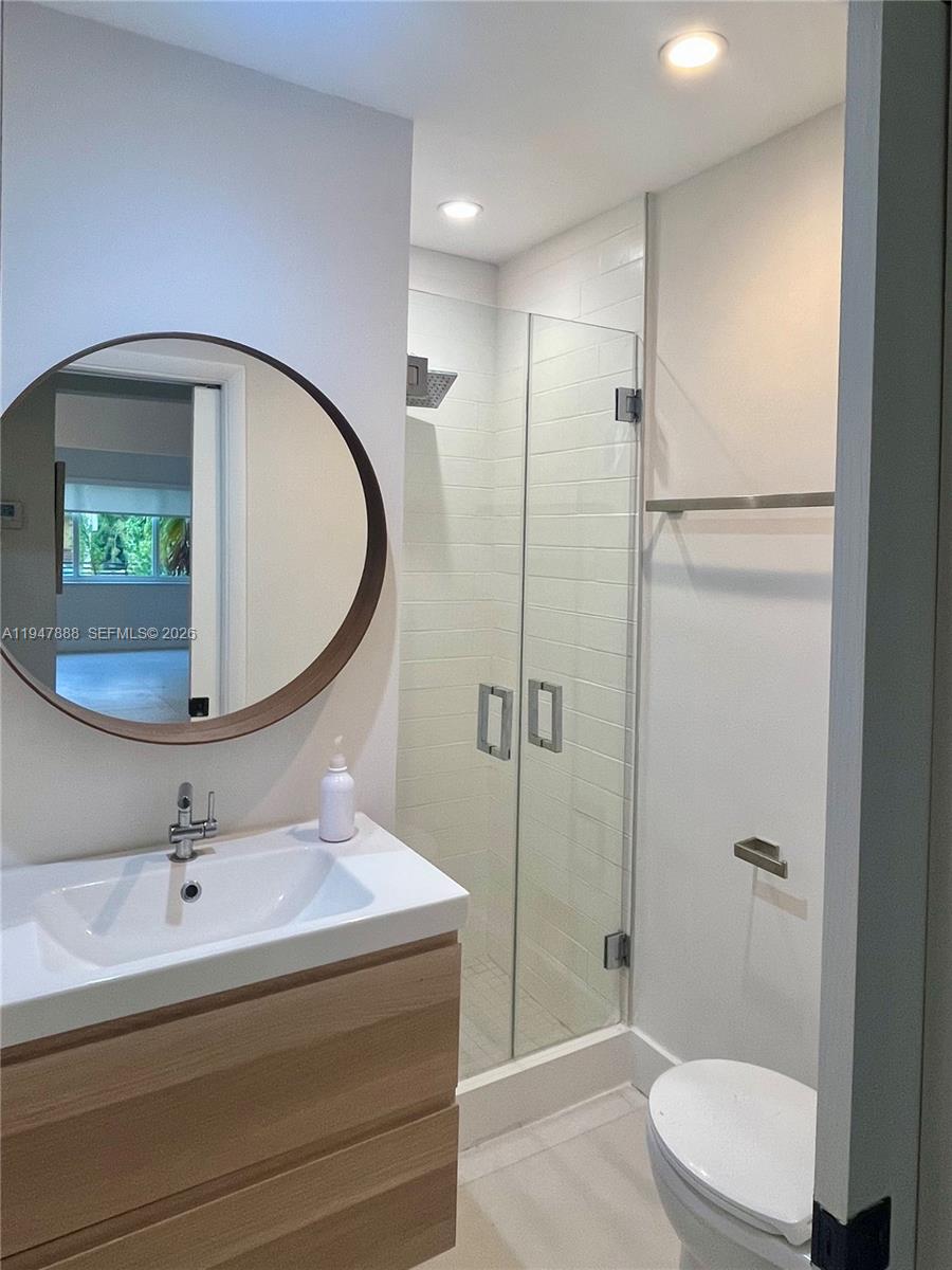 337 Southwest 23rd Road Miami, FL 33129 - Photo 18 of 30 a bathroom with a sink a toilet and shower