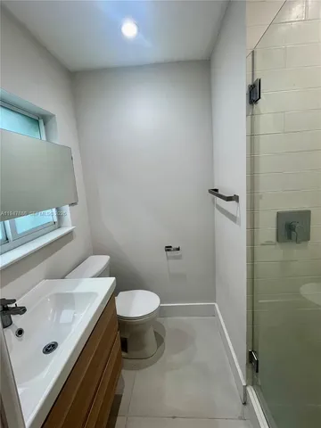 an empty room with windows and entrance