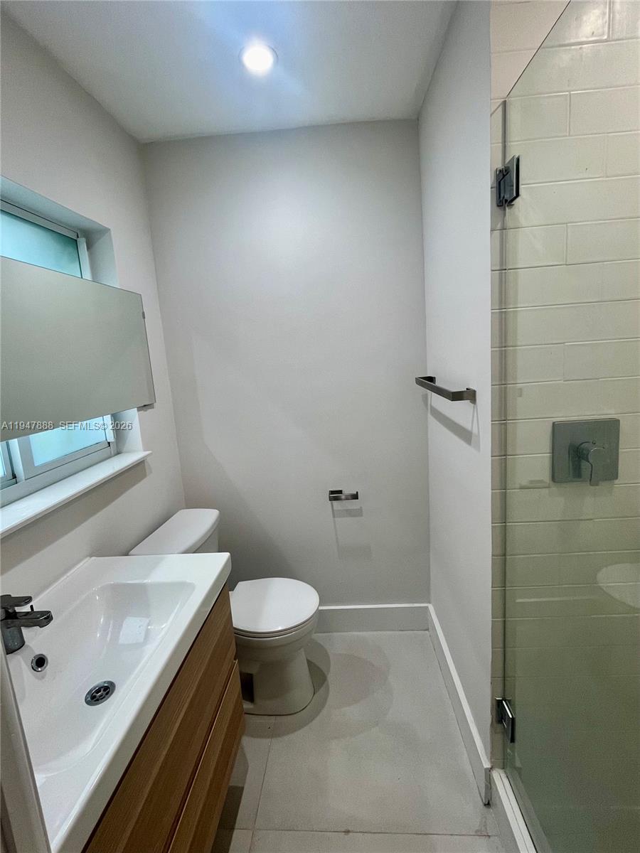 337 Southwest 23rd Road Miami, FL 33129 - Photo 19 of 30 a bathroom with a sink a toilet and shower