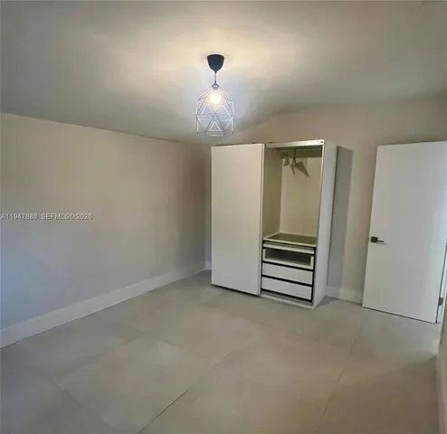 a backyard of a house with palm trees