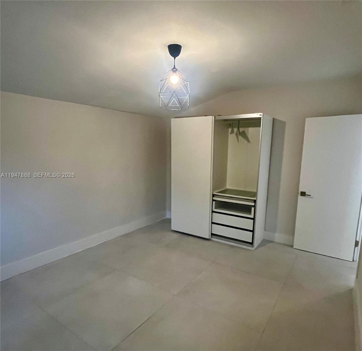 337 Southwest 23rd Road Miami, FL 33129 - Photo 25 of 30 an empty room with a chandelier