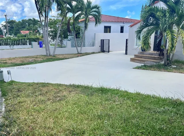 a house with palm tree in front of it