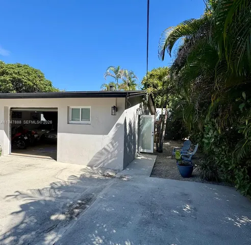 a storage room with lots of clutter and chairs
