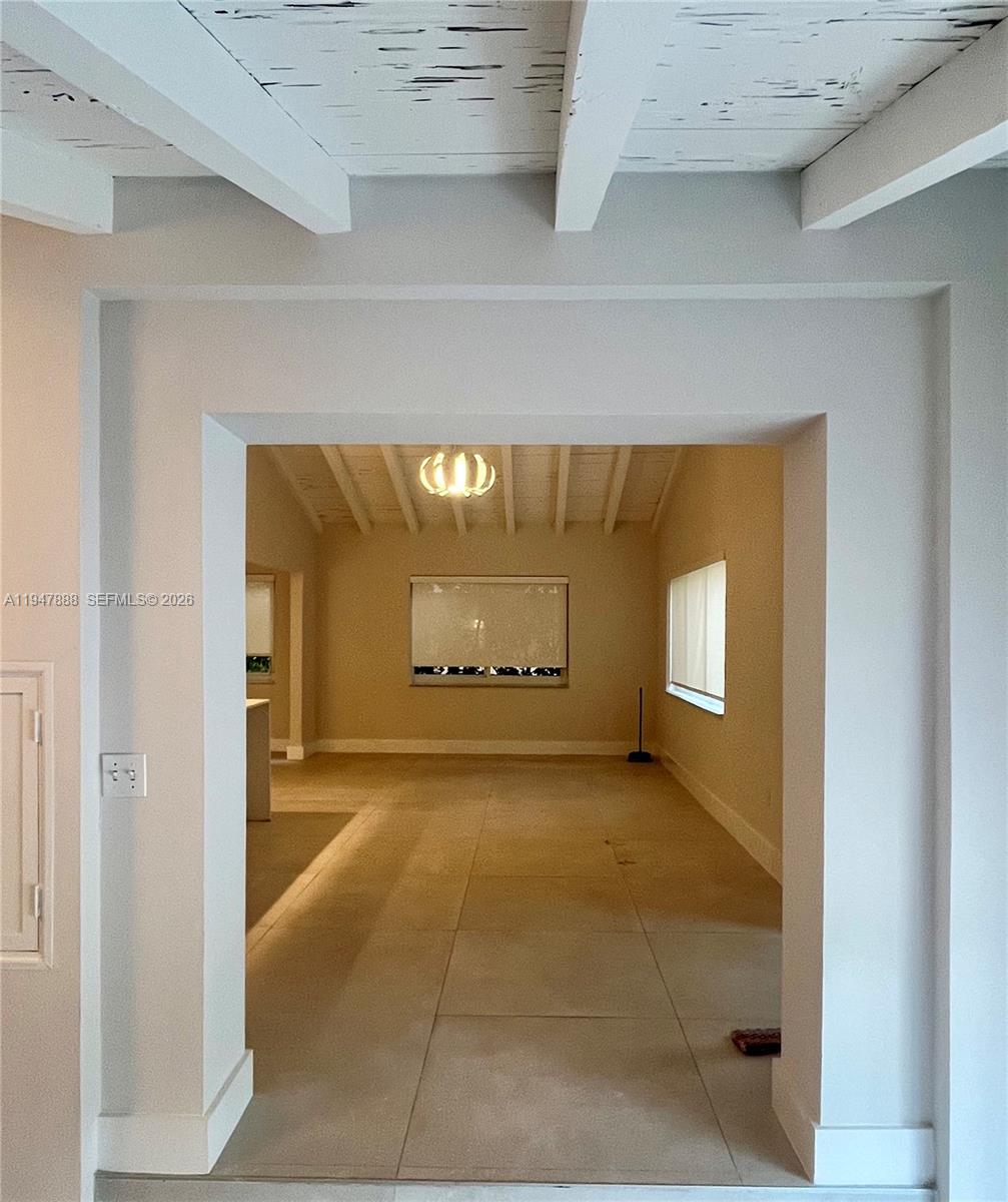 337 Southwest 23rd Road Miami, FL 33129 - Photo 7 of 30 a view of a hallway with wooden floor and a window