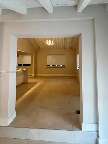 a view of a hallway with a dining room