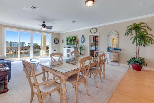 a dining room with furniture potted plants and wooden floor