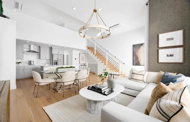a living room with furniture a rug and a chandelier