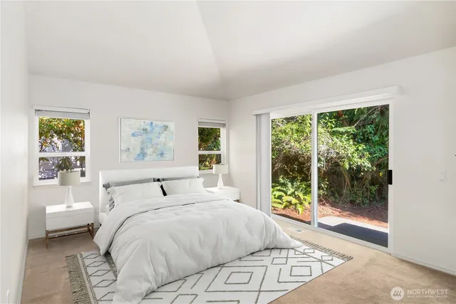 a bedroom with a large bed and a window