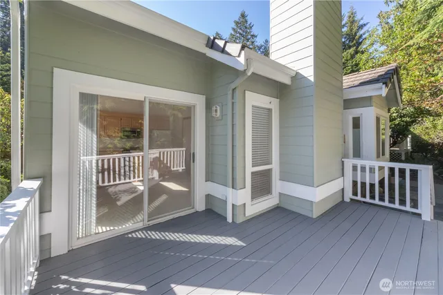 a view of a balcony with wooden floor and fence