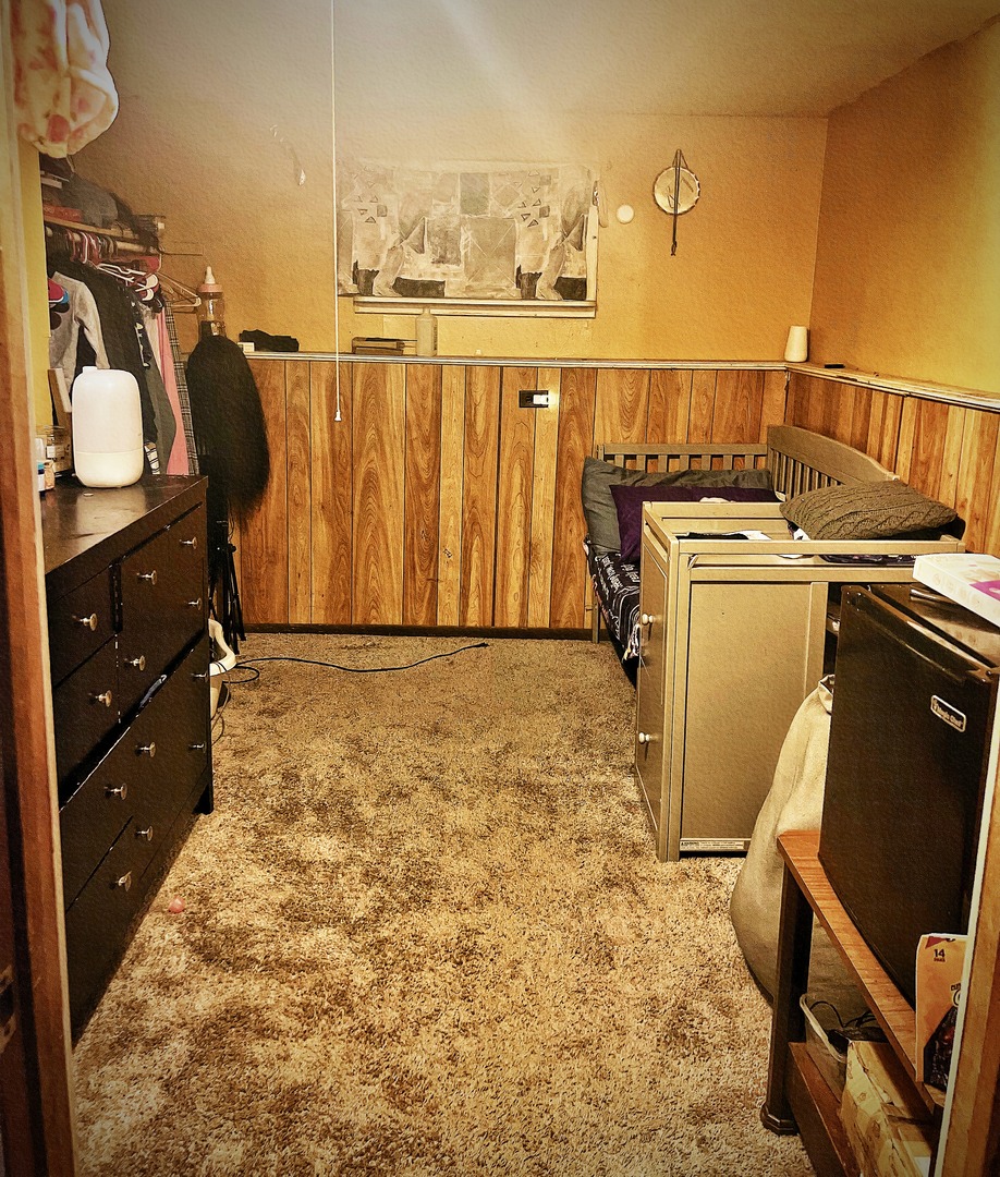 910 Bowling Green Drive Homewood, IL 60430 - Photo 12 of 14 a view of walk in closet with clothes and shoes