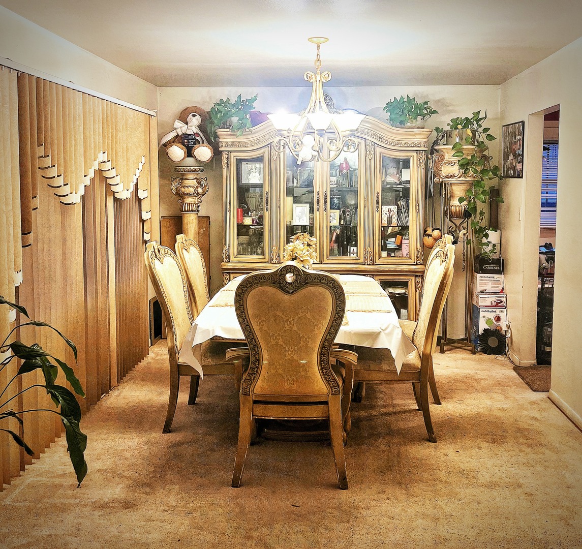 910 Bowling Green Drive Homewood, IL 60430 - Photo 3 of 14 a dining room with furniture a chandelier and wooden floor