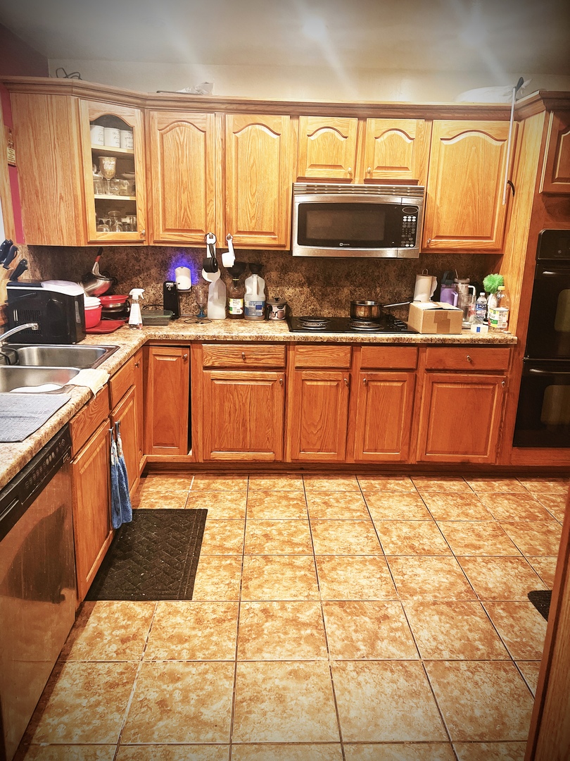 910 Bowling Green Drive Homewood, IL 60430 - Photo 6 of 14 a kitchen with stainless steel appliances granite countertop a stove a sink and a microwave