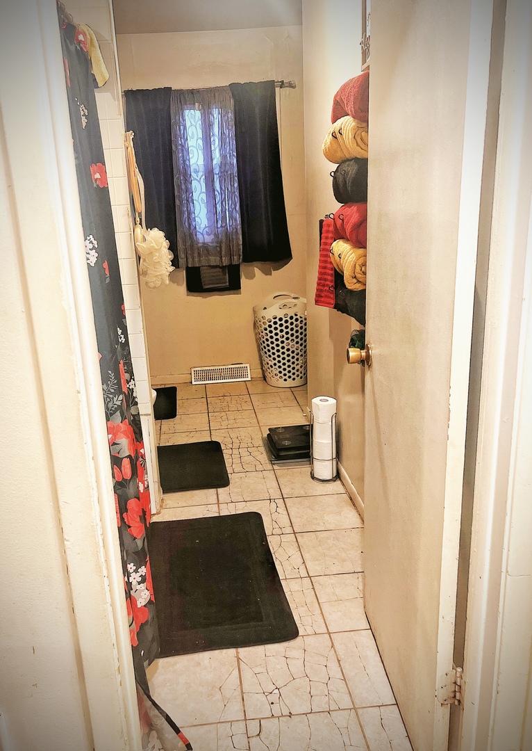 910 Bowling Green Drive Homewood, IL 60430 - Photo 7 of 14 a bedroom with a bed and a window