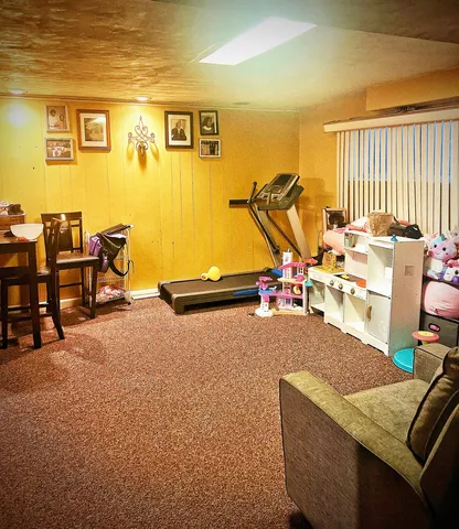 a view of a livingroom with furniture and a window
