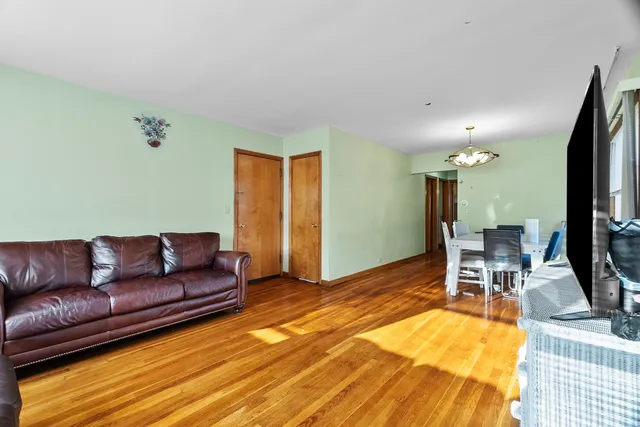 a living room with furniture a flat screen tv and a table