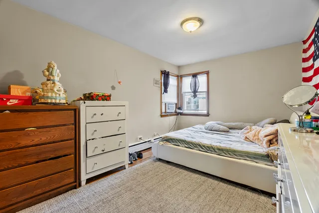 a bedroom with a bed and a dresser