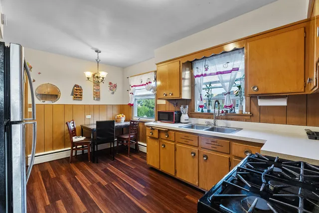 a kitchen with a sink appliances and a counter top space
