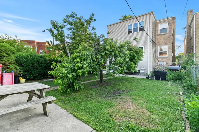 a view of a backyard with plants and a patio