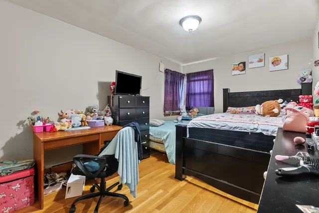 a bedroom with a bed and a desk