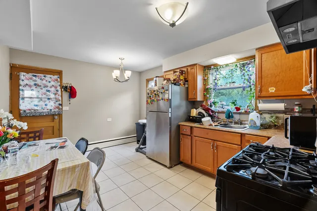a kitchen with stainless steel appliances granite countertop a stove top oven a sink dishwasher and a refrigerator