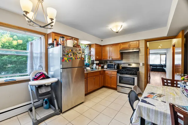 a kitchen with stainless steel appliances granite countertop a refrigerator and a stove top oven