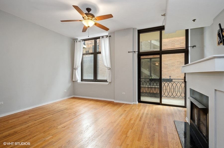 1201 West Adams Street, Unit 609 Chicago, IL 60607 - Photo 4 of 13 a view of an empty room with a window and wooden floor