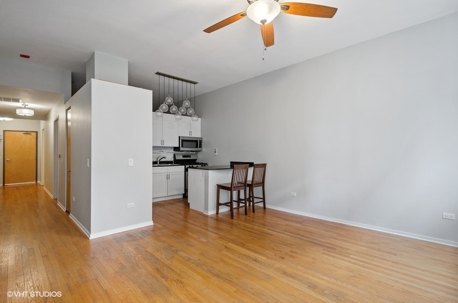 1201 West Adams Street, Unit 609 Chicago, IL 60607 - Photo 6 of 13 a view of kitchen with furniture and wooden floor
