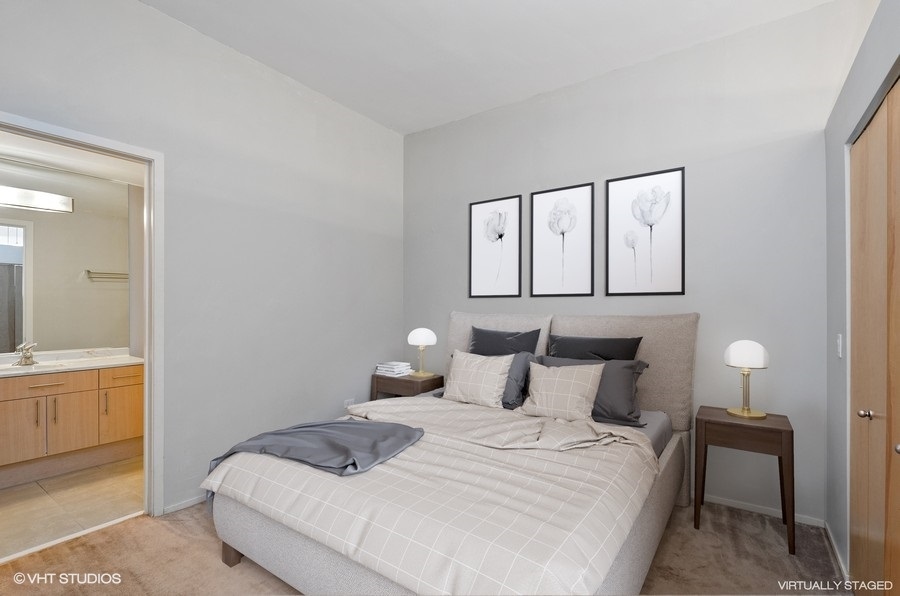 1201 West Adams Street, Unit 609 Chicago, IL 60607 - Photo 7 of 13 a bedroom with a bed and a cabinets