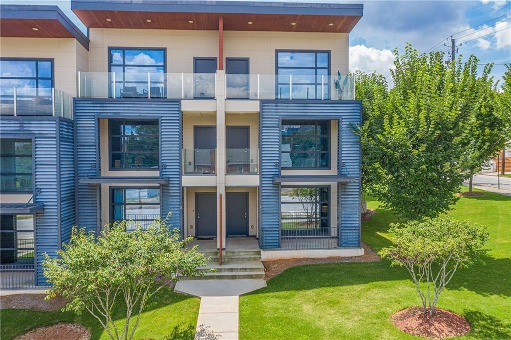 a front view of a building with a garden and plants