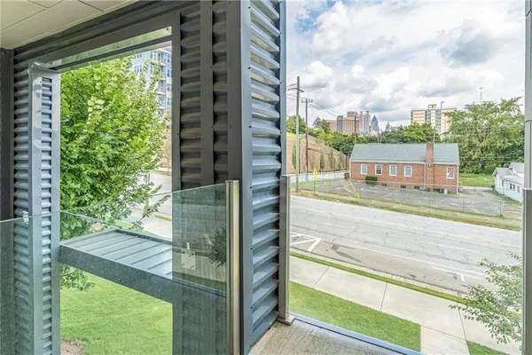 a view of a balcony with a floor to ceiling window plants and floor to ceiling window