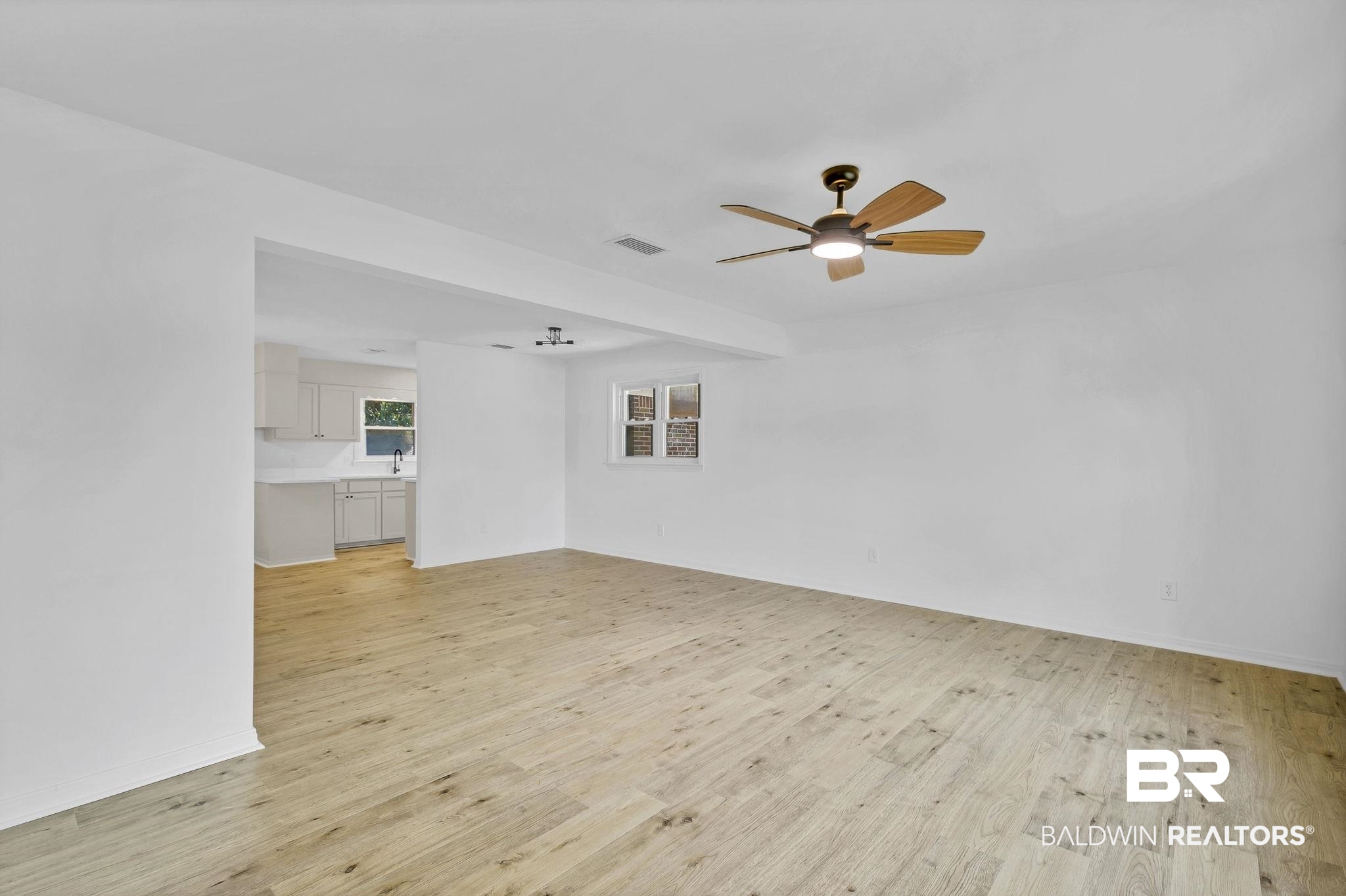 203 Anderson Road Saraland, AL 36571 - Photo 5 of 48 Empty room featuring visible vents, baseboards, light wood finished floors, and a ceiling fan
