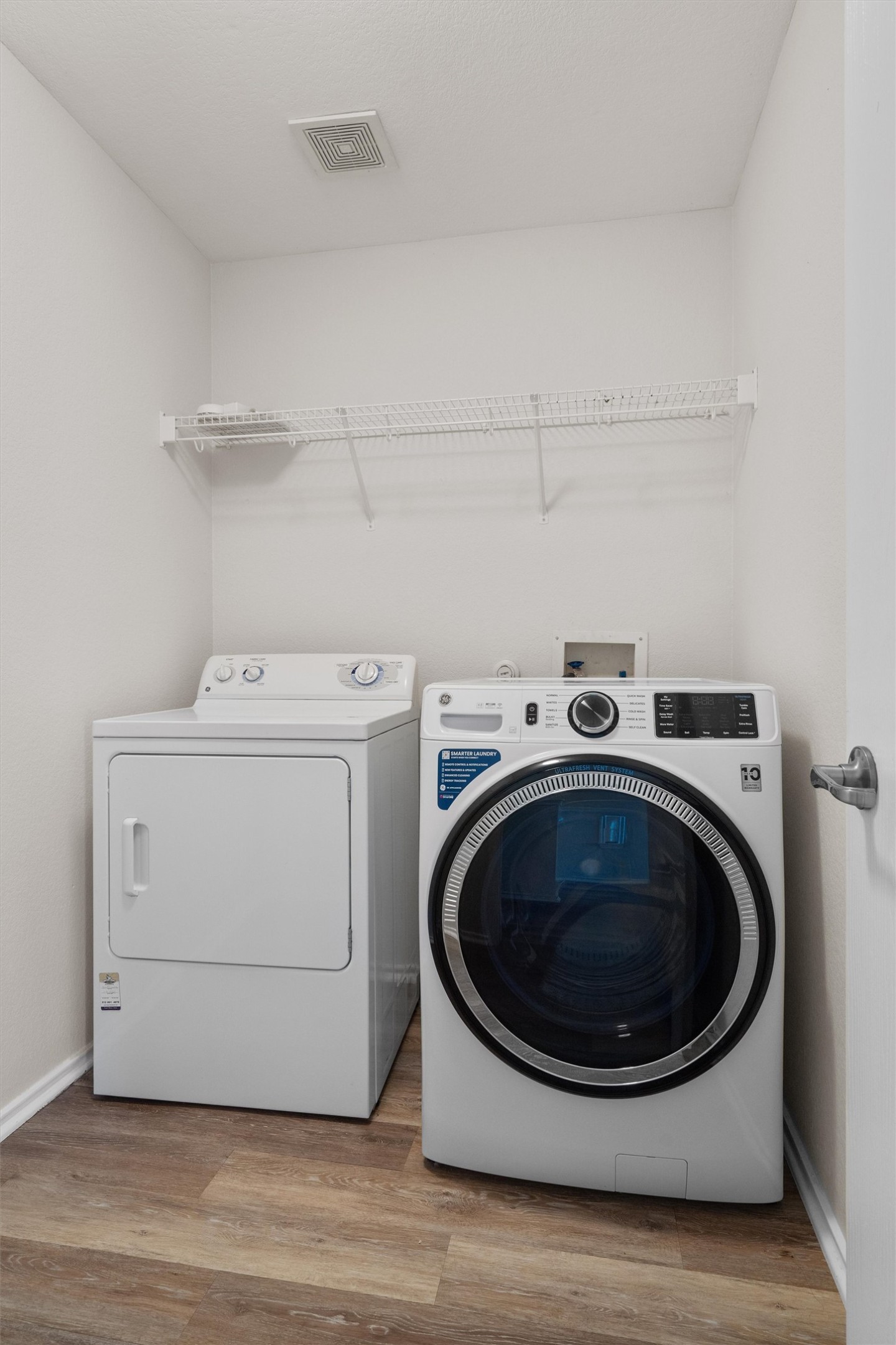 5825 Silver Screen Drive Austin, TX 78747 - Photo 26 of 40 Functional laundry space featuring modern appliances and practical wire shelving for convenience.